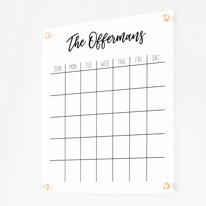 A Dry-erase monthly calender made of acrylic hanging on the wall