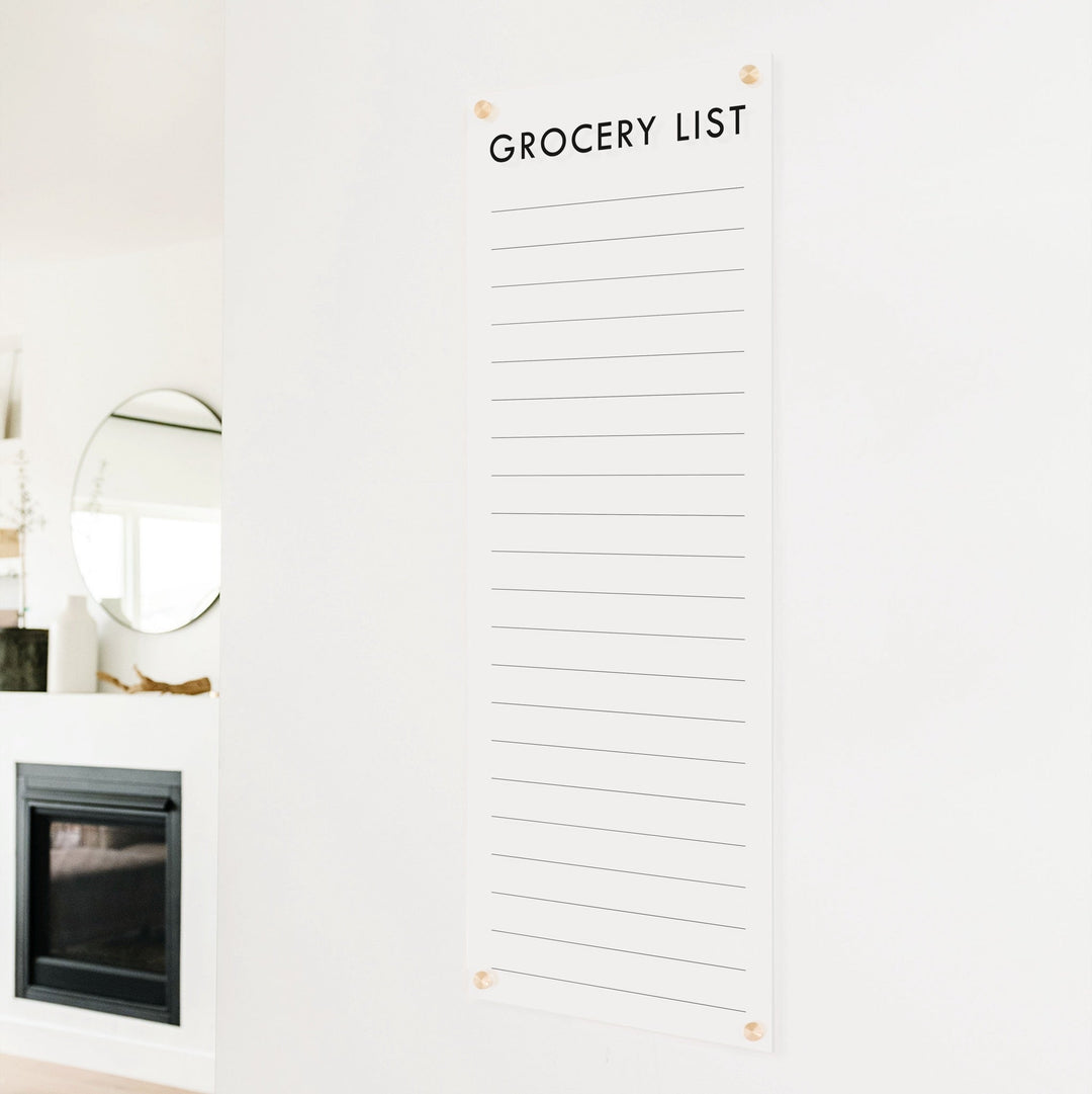 A dry-erase to do list made of acrylic hanging on the wall