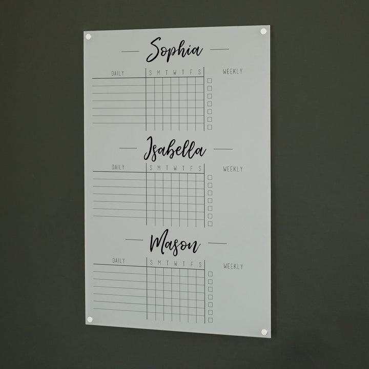 A Dry-erase acrylic chore chart hanging on the wall