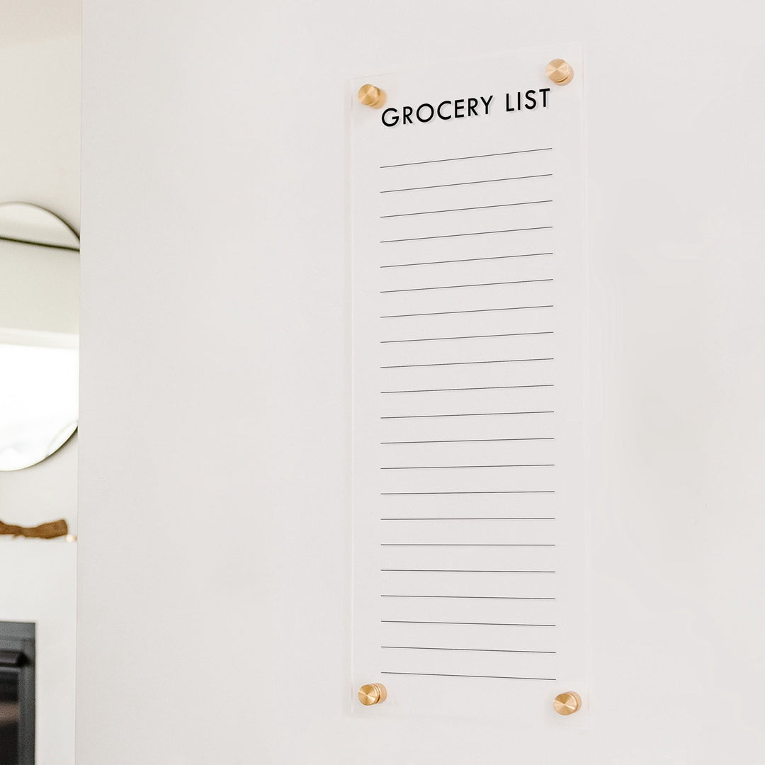 A dry-erase to do list made of acrylic hanging on the wall