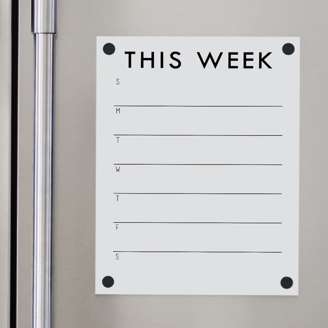 A Dry-erase weekly calender made of magnetic acrylic hanging on the fridge