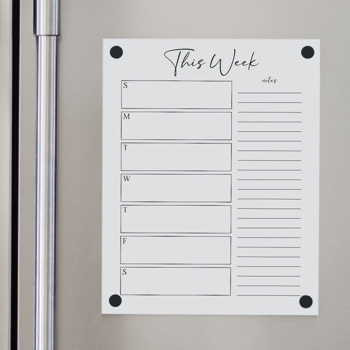 A Dry-erase weekly calender made of magnetic acrylic hanging on the fridge