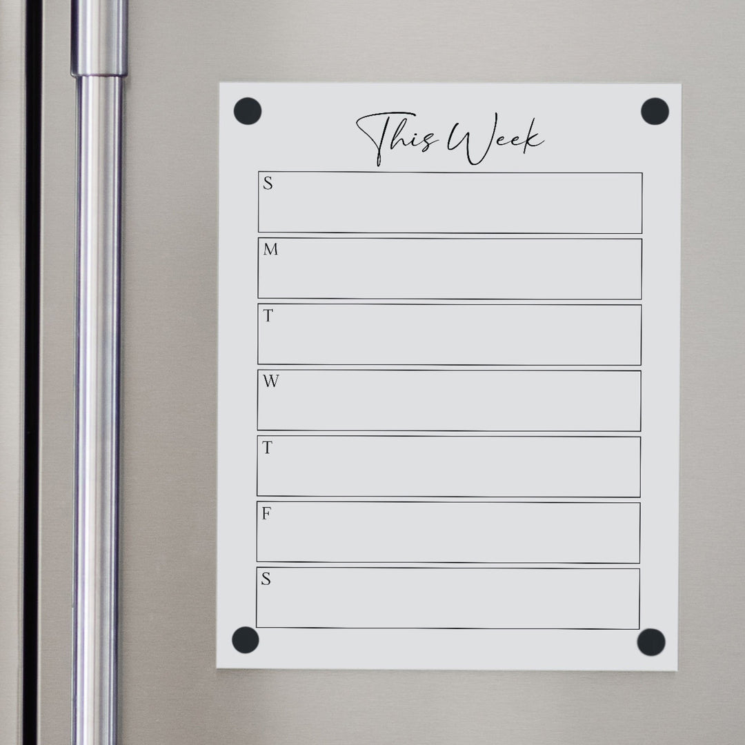 A Dry-erase weekly calender made of magnetic acrylic hanging on the fridge