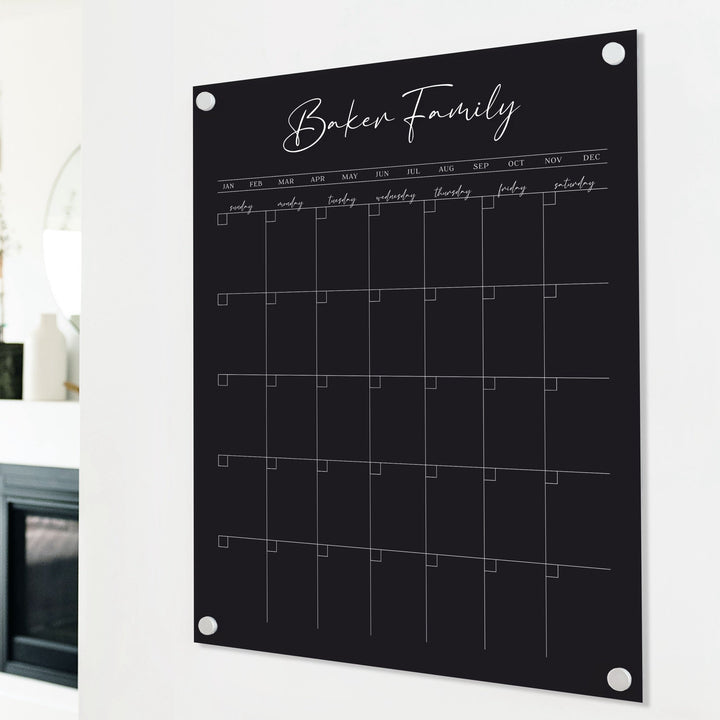 A Dry-erase monthly calender made of acrylic hanging on the wall