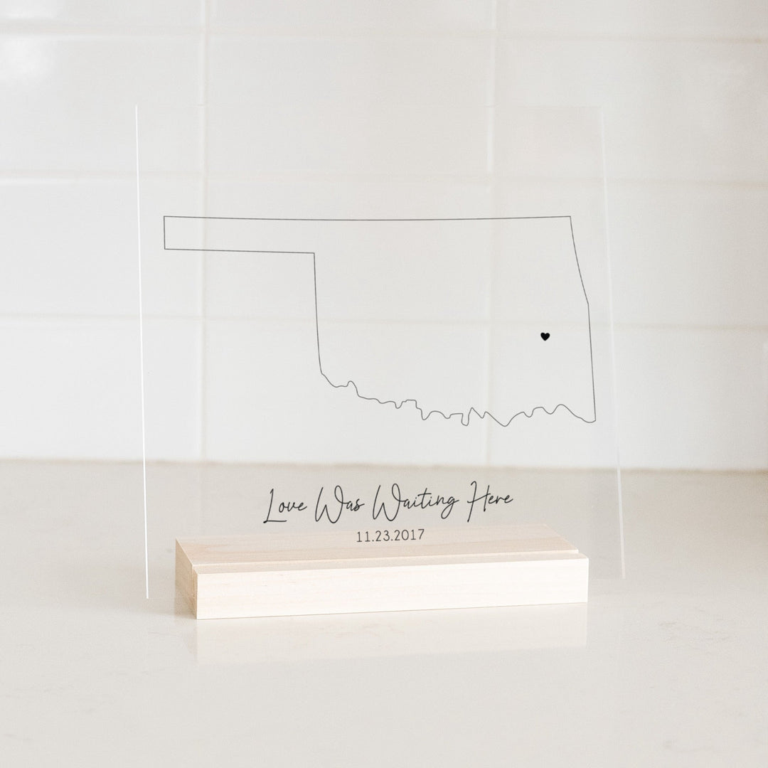 Clear acrylic sign with wood base featuring an Oklahoma location and custom text