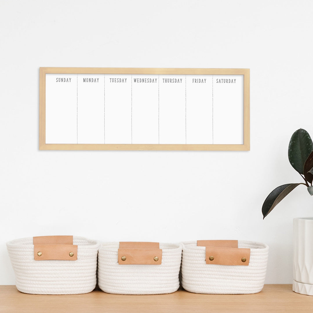 A framed dry-erase to do list with a chalkboard look hanging on the wall