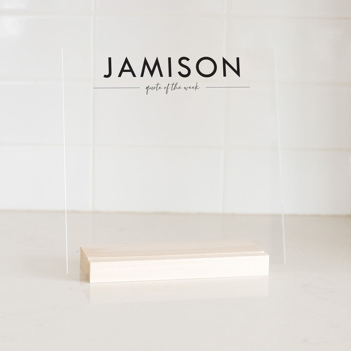 A custom 8x8 acrylic decor sign for weekly quotes on a kitchen counter.