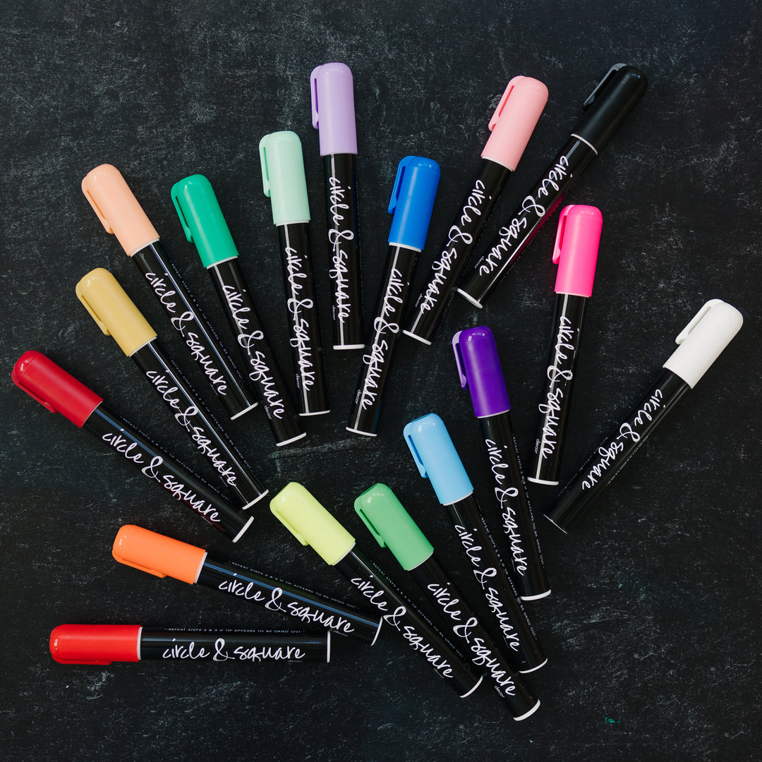 an assortment of colors of circle and square markers