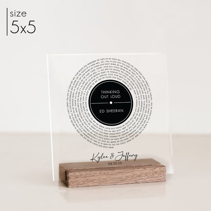 A custom 5x5 acrylic decor sign with a record design and personalized title printed on it.