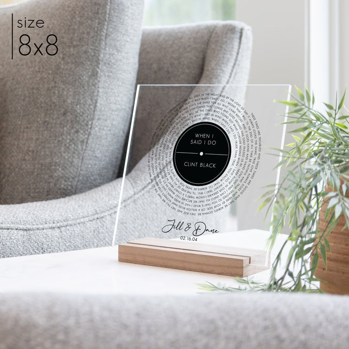 A custom anniversary gift on clear acrylic featuring custom titles and a record design.