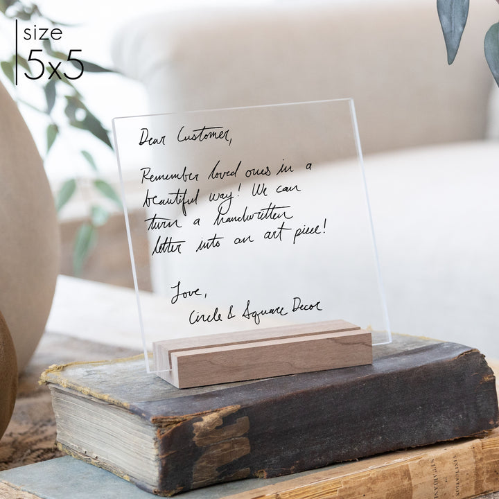 A custom handwriting keepsake in the size 5x5 with a wooden stand.