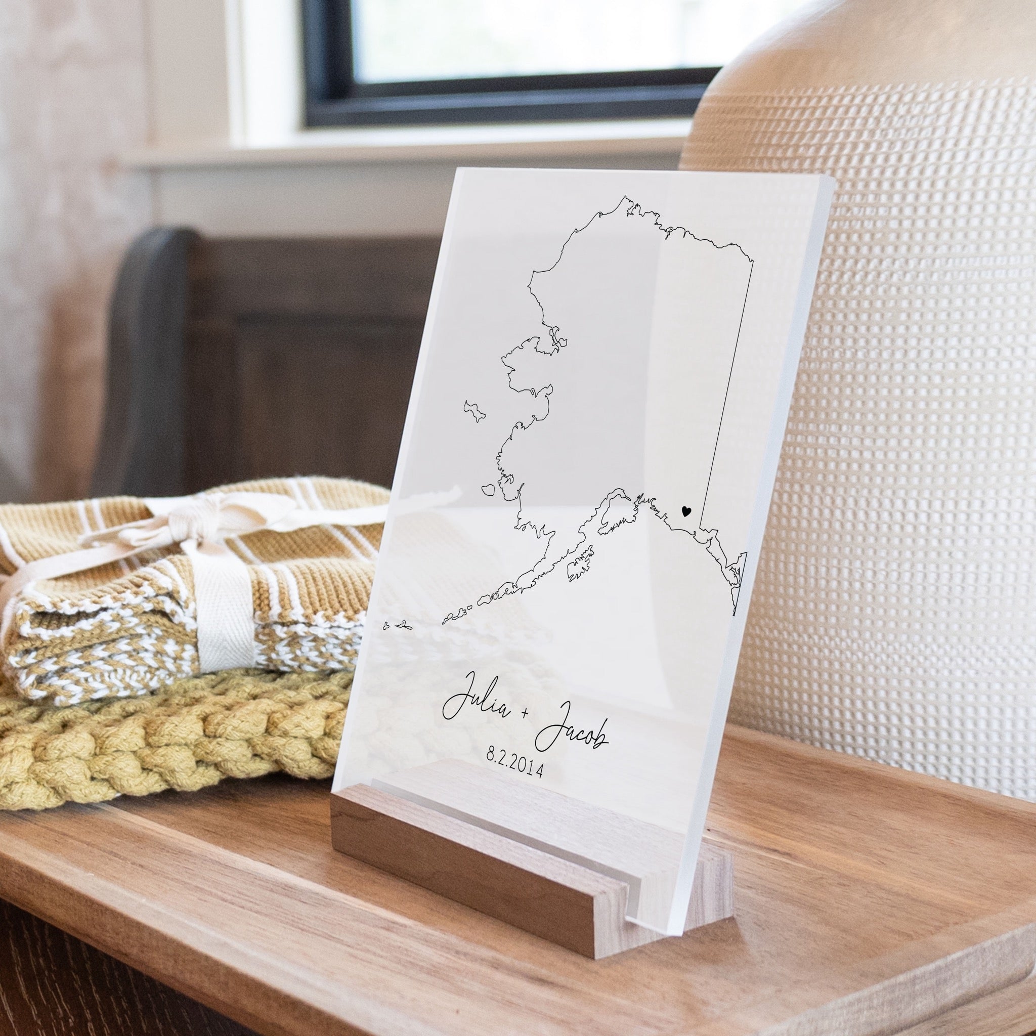 Clear acrylic sign with wood base featuring an Alaska location and custom text