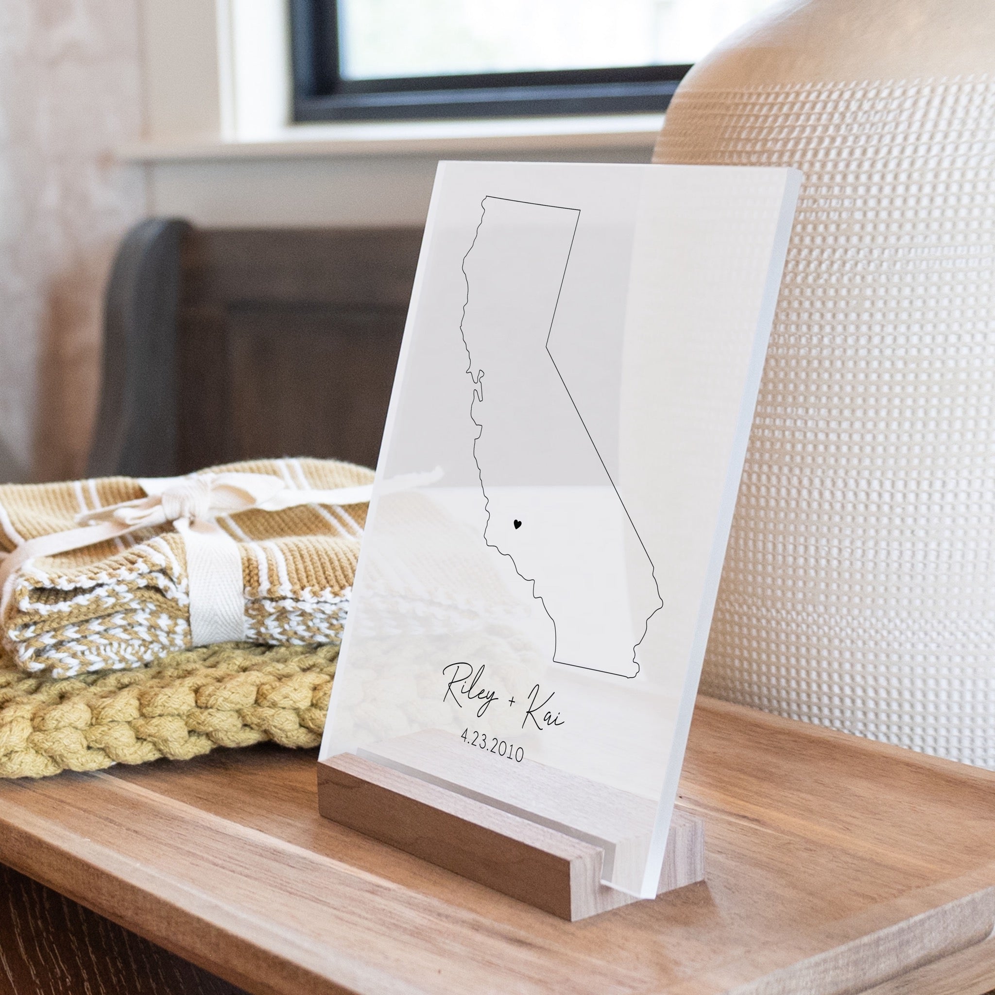 Clear acrylic sign with wood base featuring a California location and custom text
