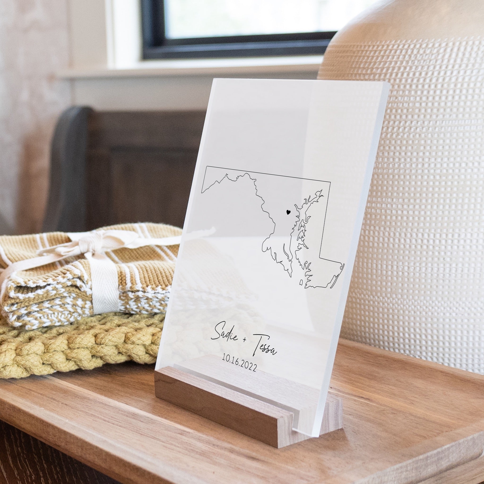 Clear acrylic sign with wood base featuring a Maryland location and custom text