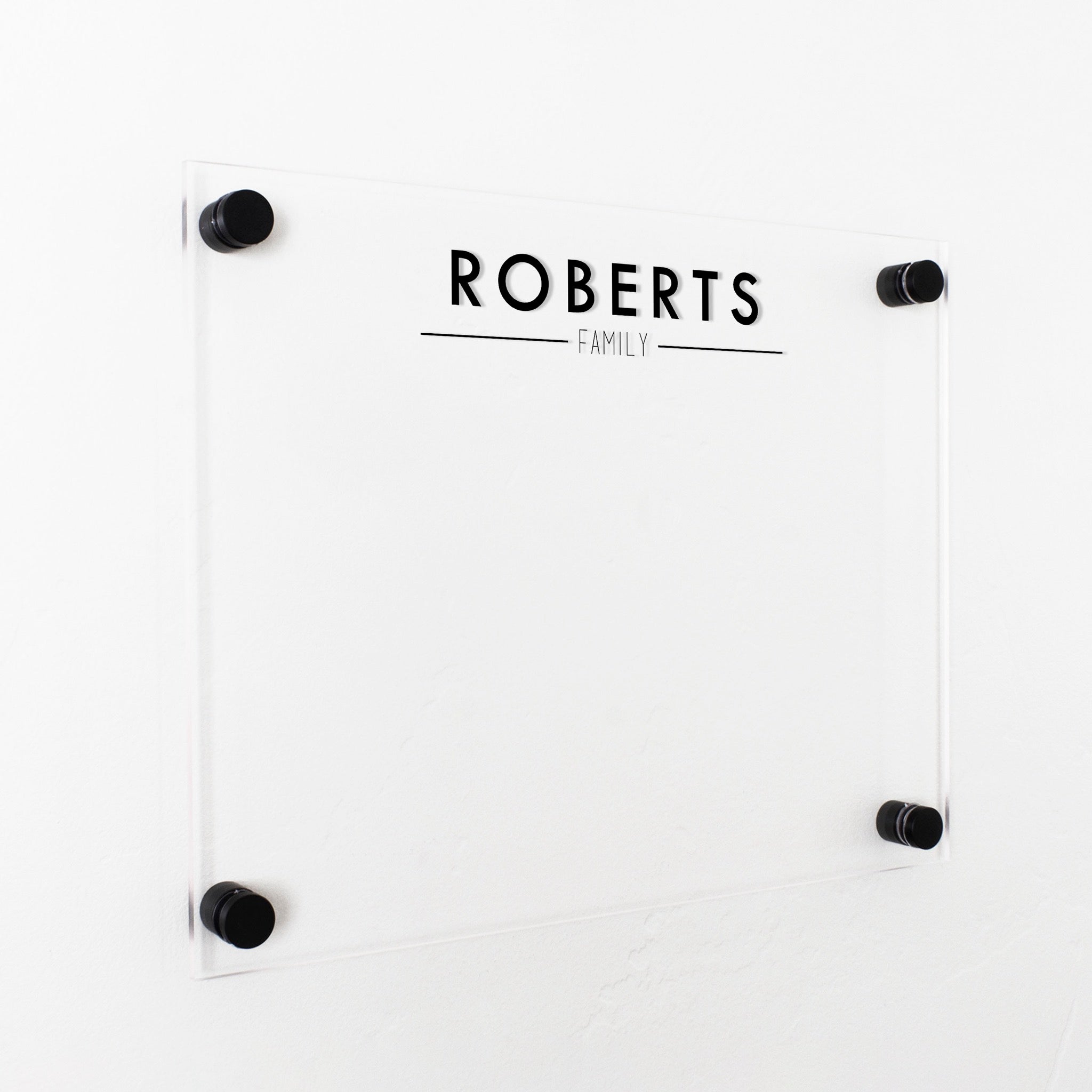A dry-erase board made of clear acrylic with a custom title up top