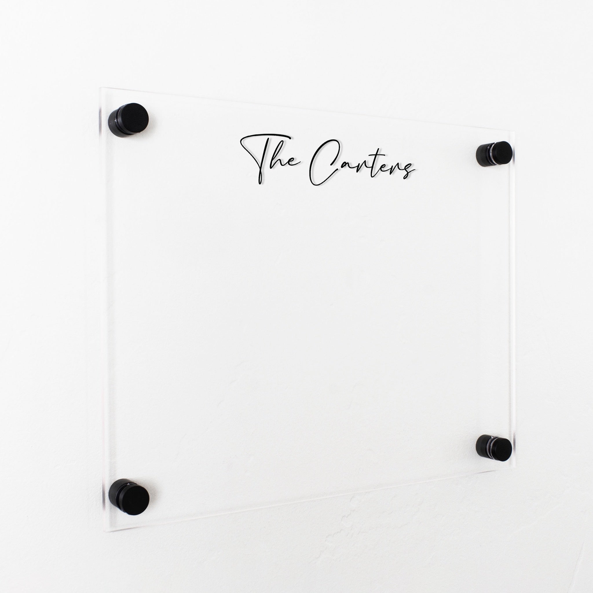 A dry-erase board made of clear acrylic with a custom title up top
