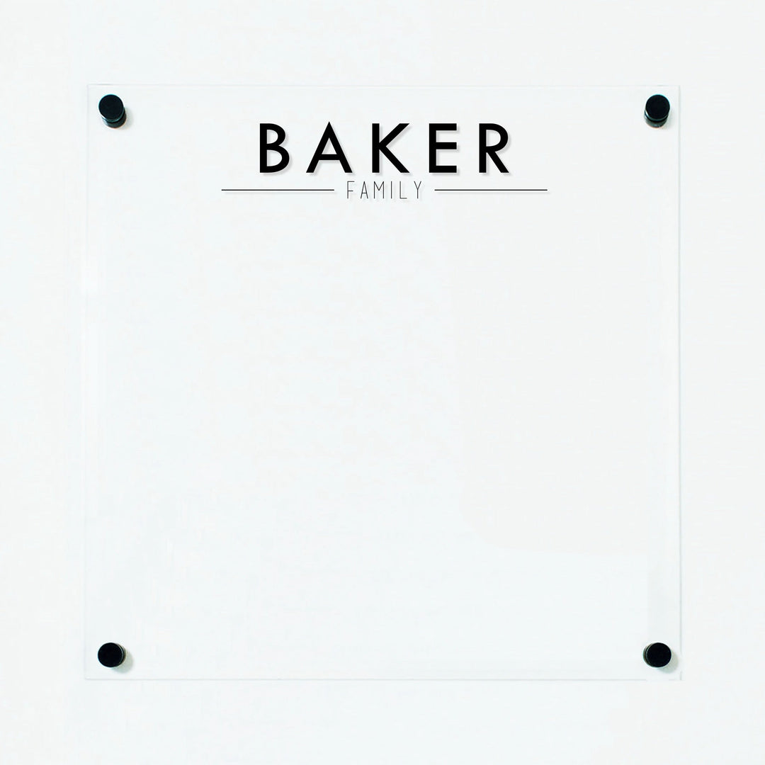 A dry-erase board made of clear acrylic with a custom title up top