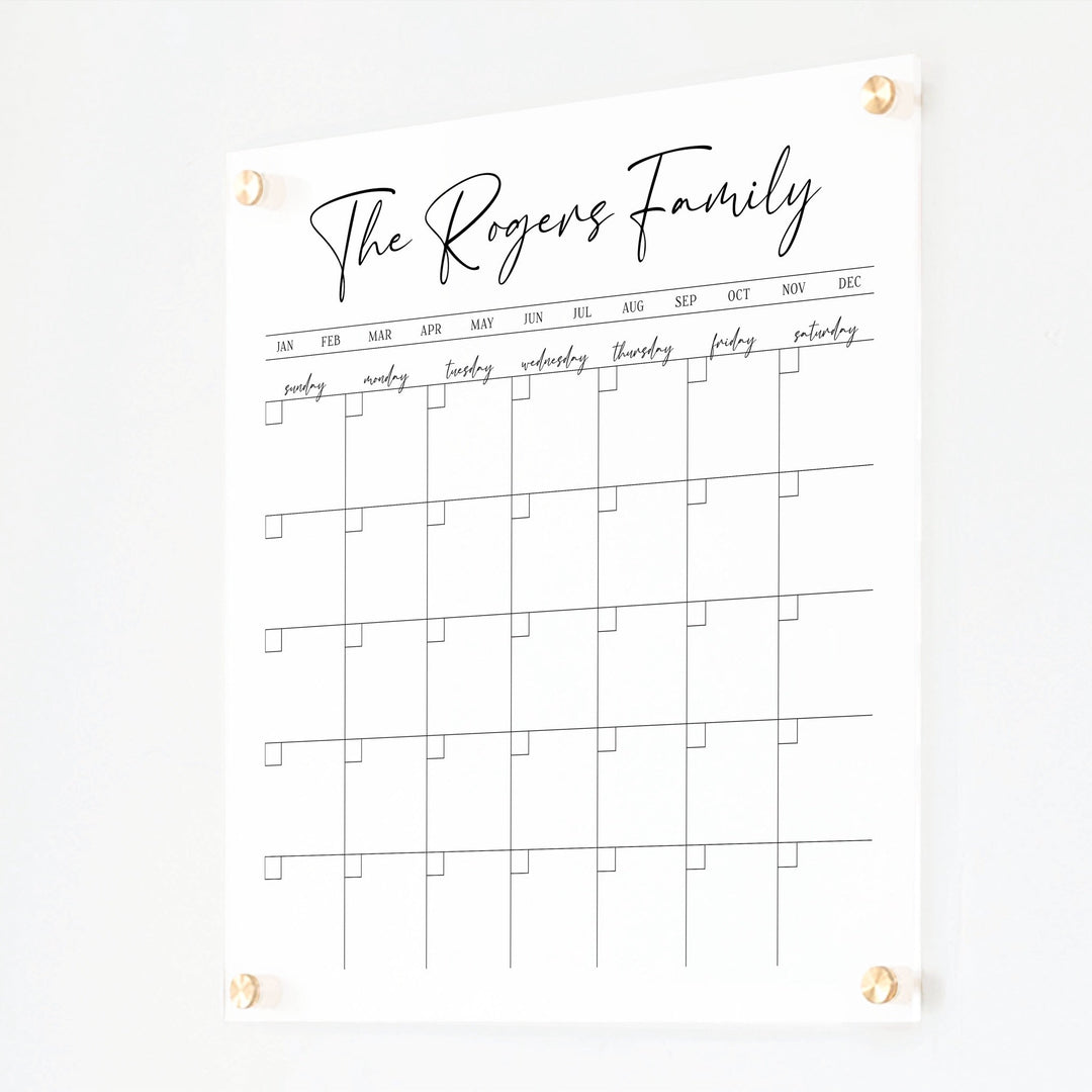 A Dry-erase monthly calender made of acrylic hanging on the wall