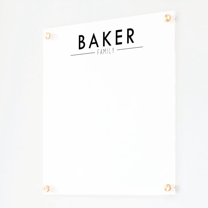 A dry-erase board made of clear acrylic with a custom title up top