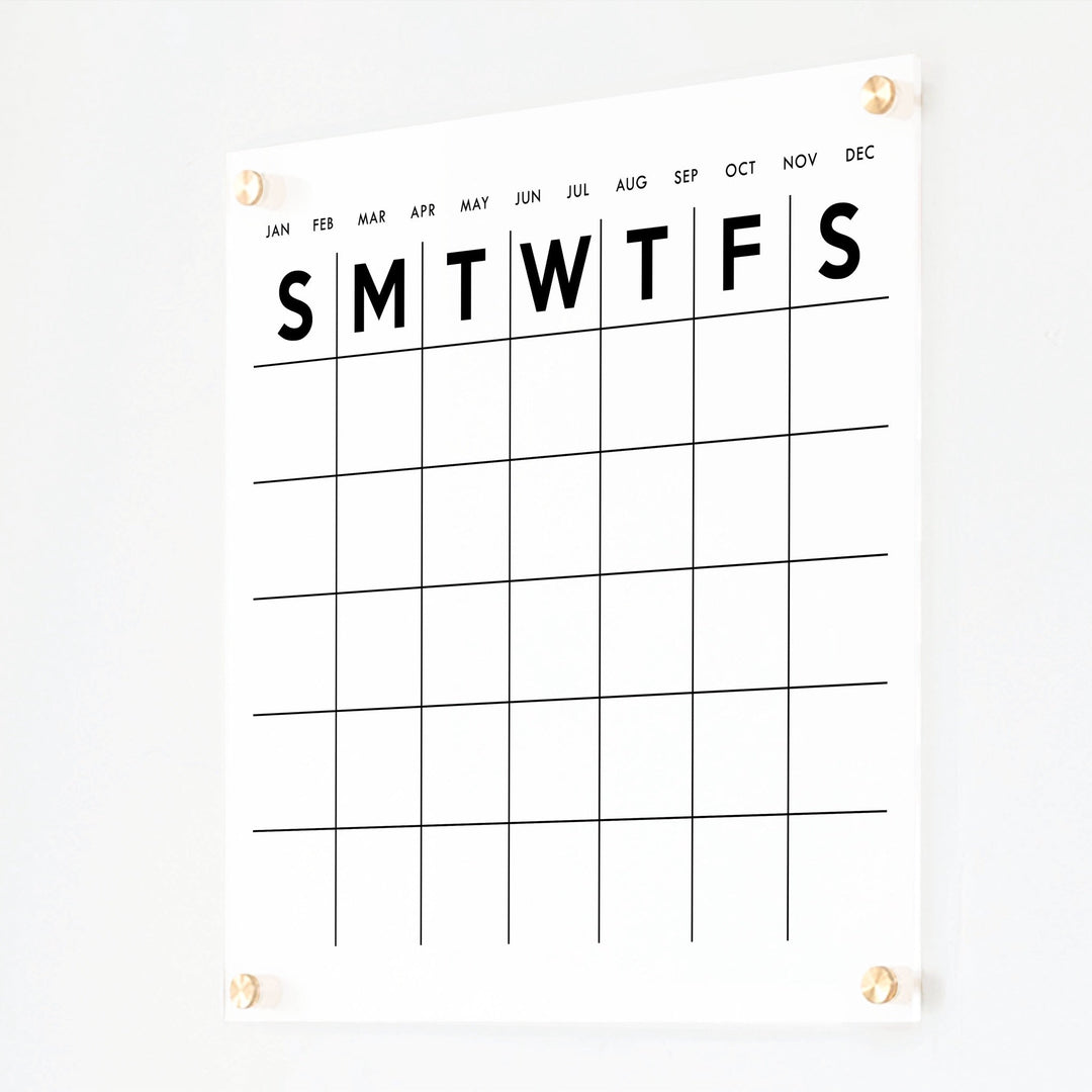 A Dry-erase monthly calender made of acrylic hanging on the wall