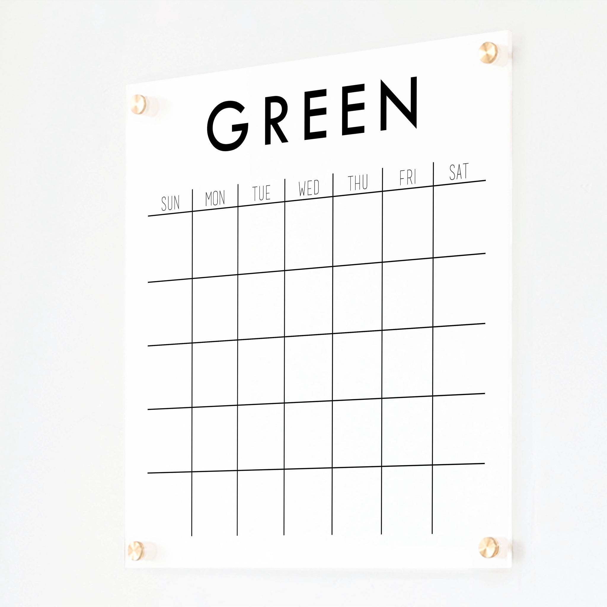 A Dry-erase monthly calender made of acrylic hanging on the wall