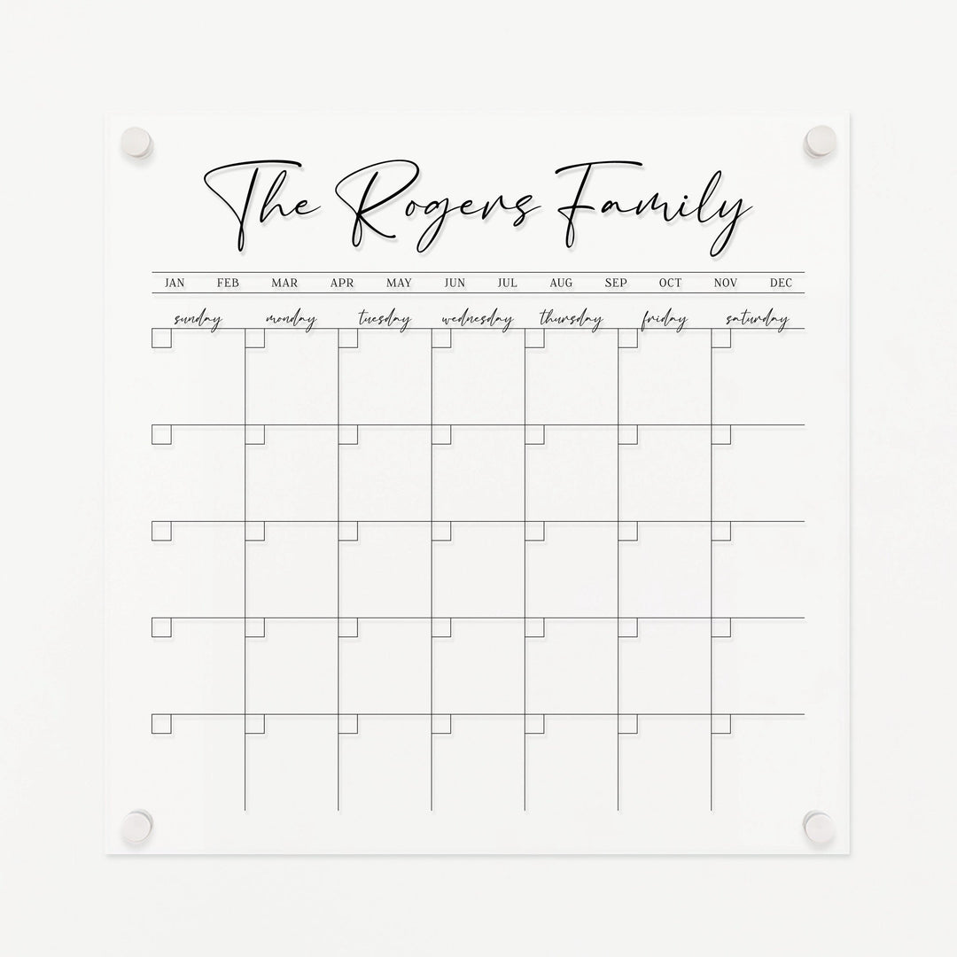 A Dry-erase monthly calender made of acrylic hanging on the wall
