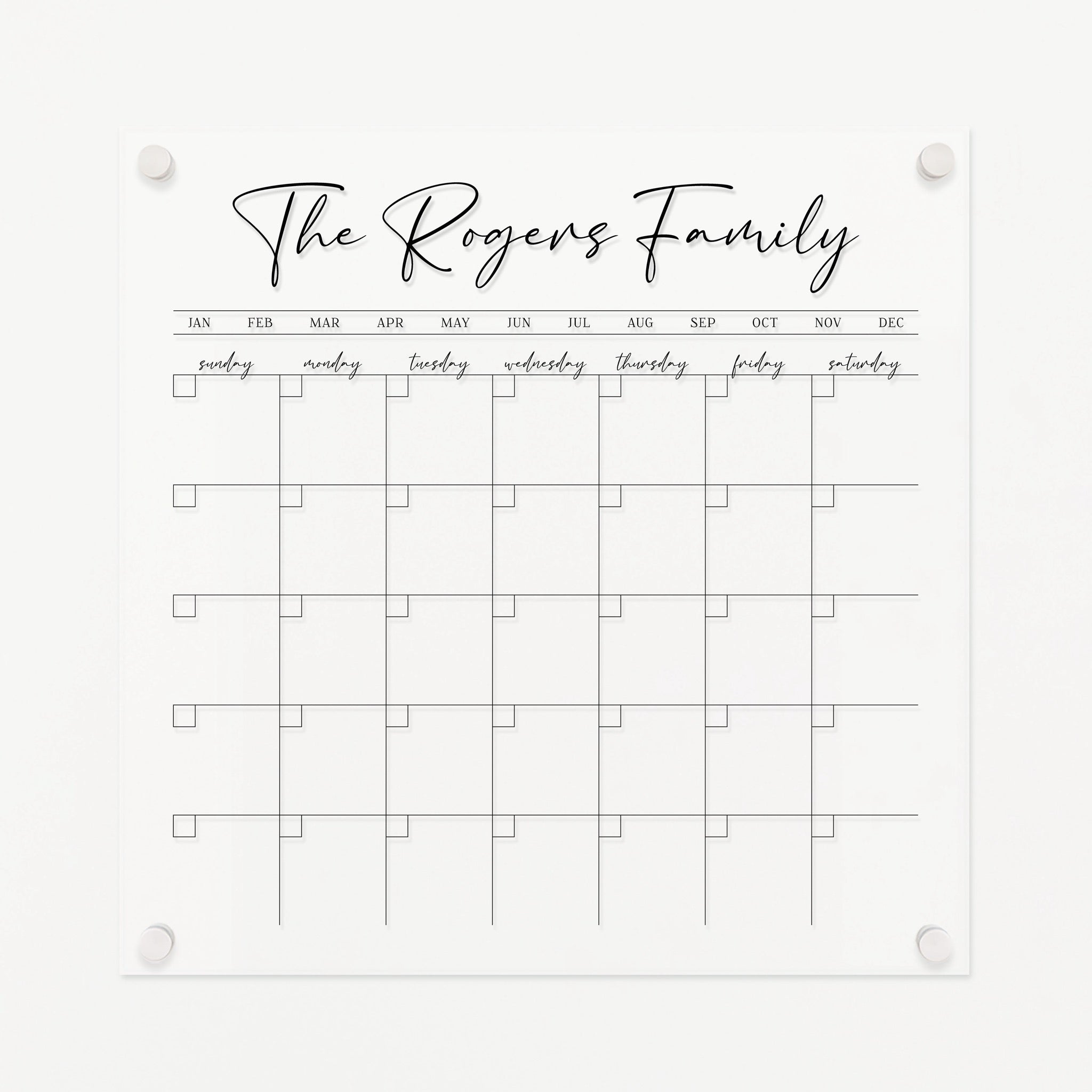 A Dry-erase monthly calender made of acrylic hanging on the wall