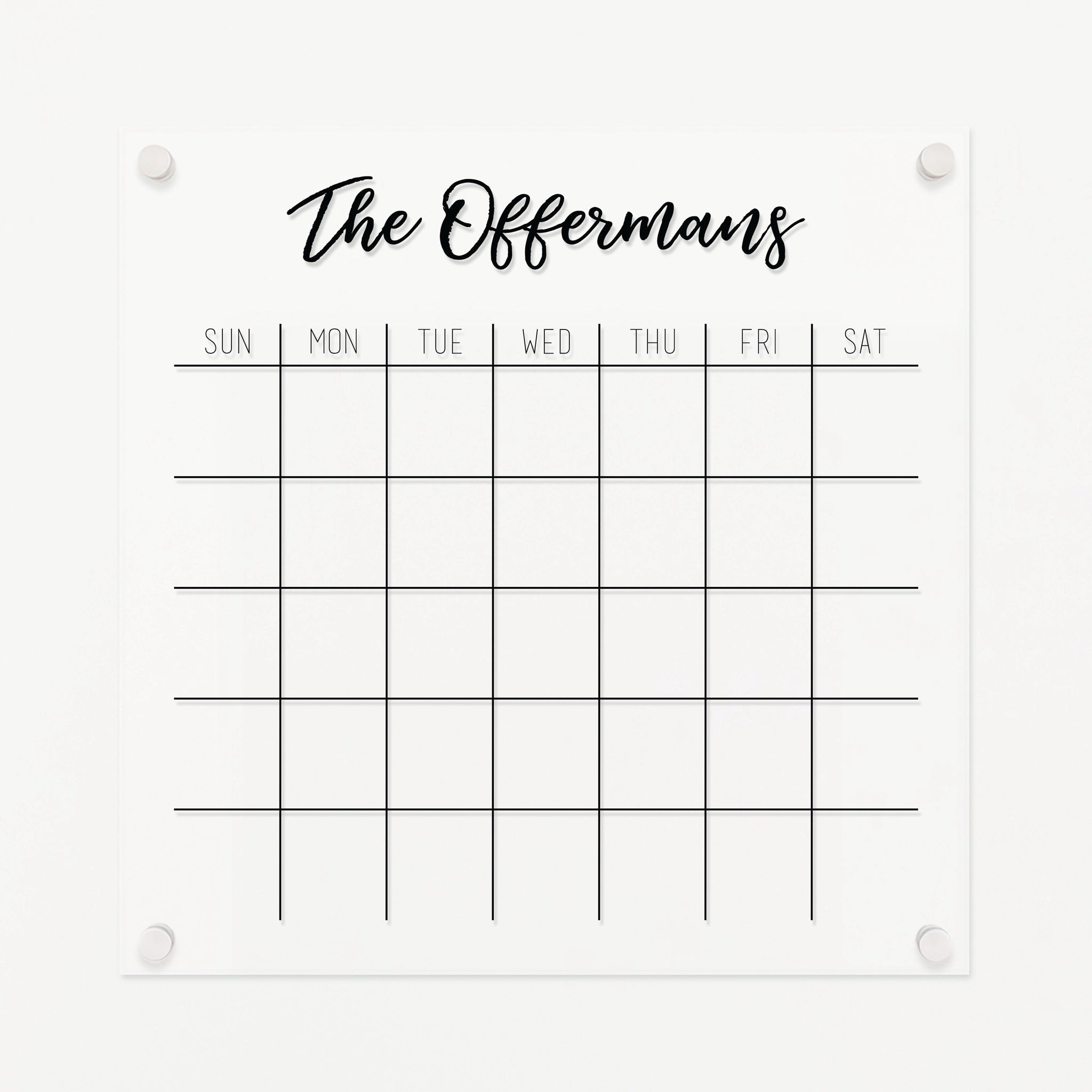 A Dry-erase monthly calender made of acrylic hanging on the wall