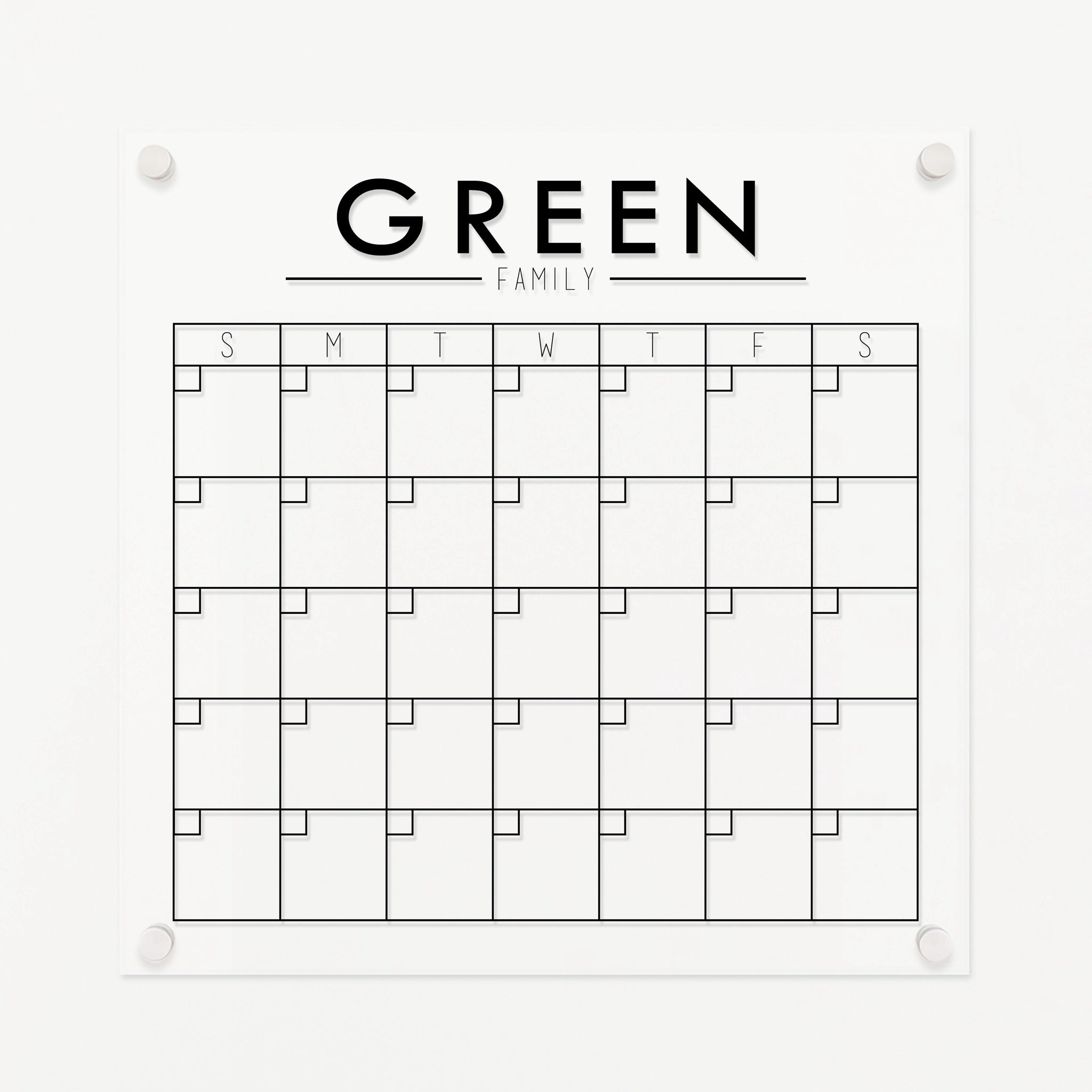 A Dry-erase monthly calender made of acrylic hanging on the wall