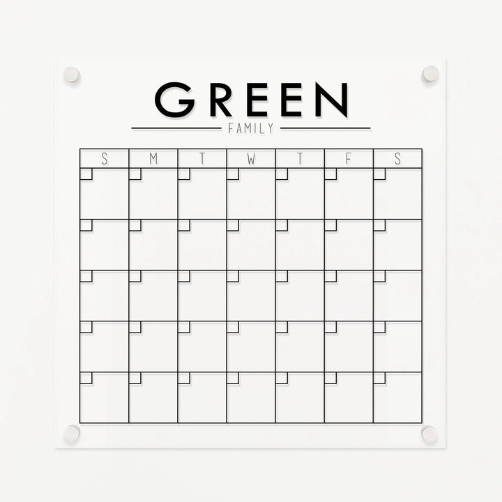 A Dry-erase monthly calender made of acrylic hanging on the wall