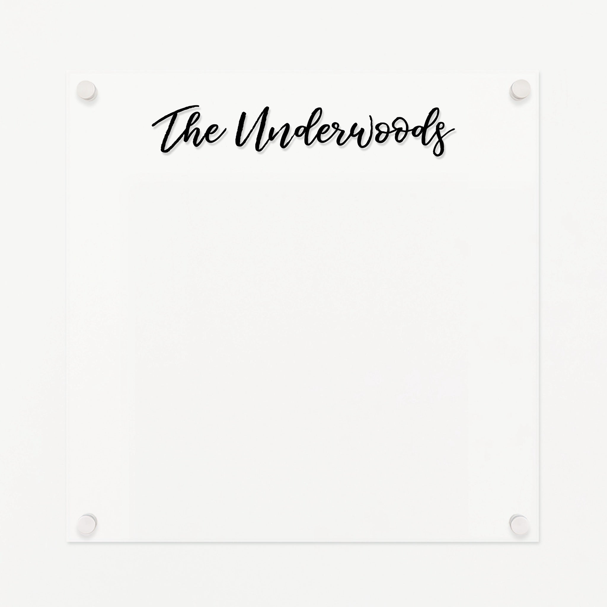 A dry-erase board made of clear acrylic with a custom title up top