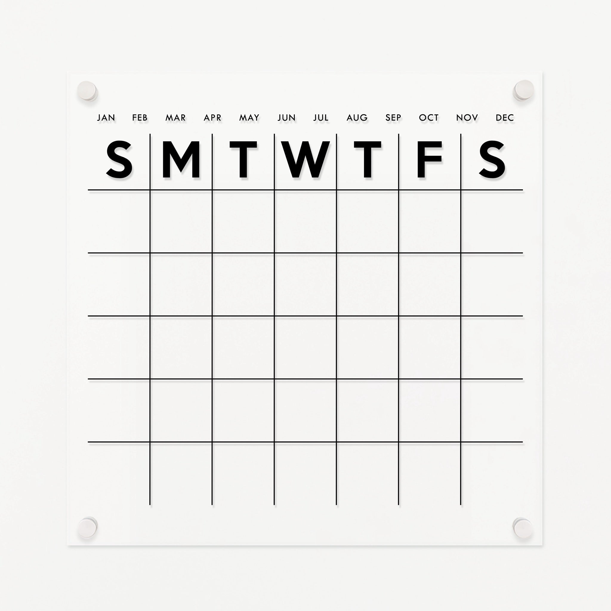 A Dry-erase monthly calender made of acrylic hanging on the wall