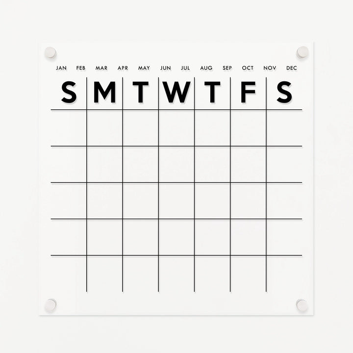A Dry-erase monthly calender made of acrylic hanging on the wall