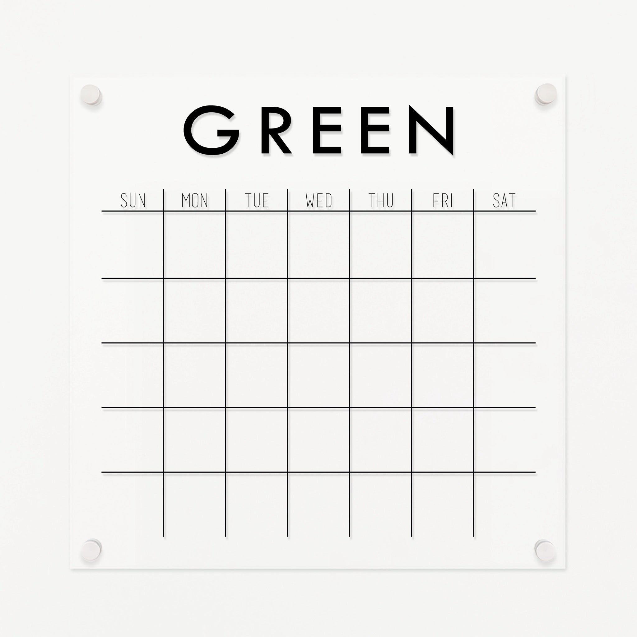A Dry-erase monthly calender made of acrylic hanging on the wall