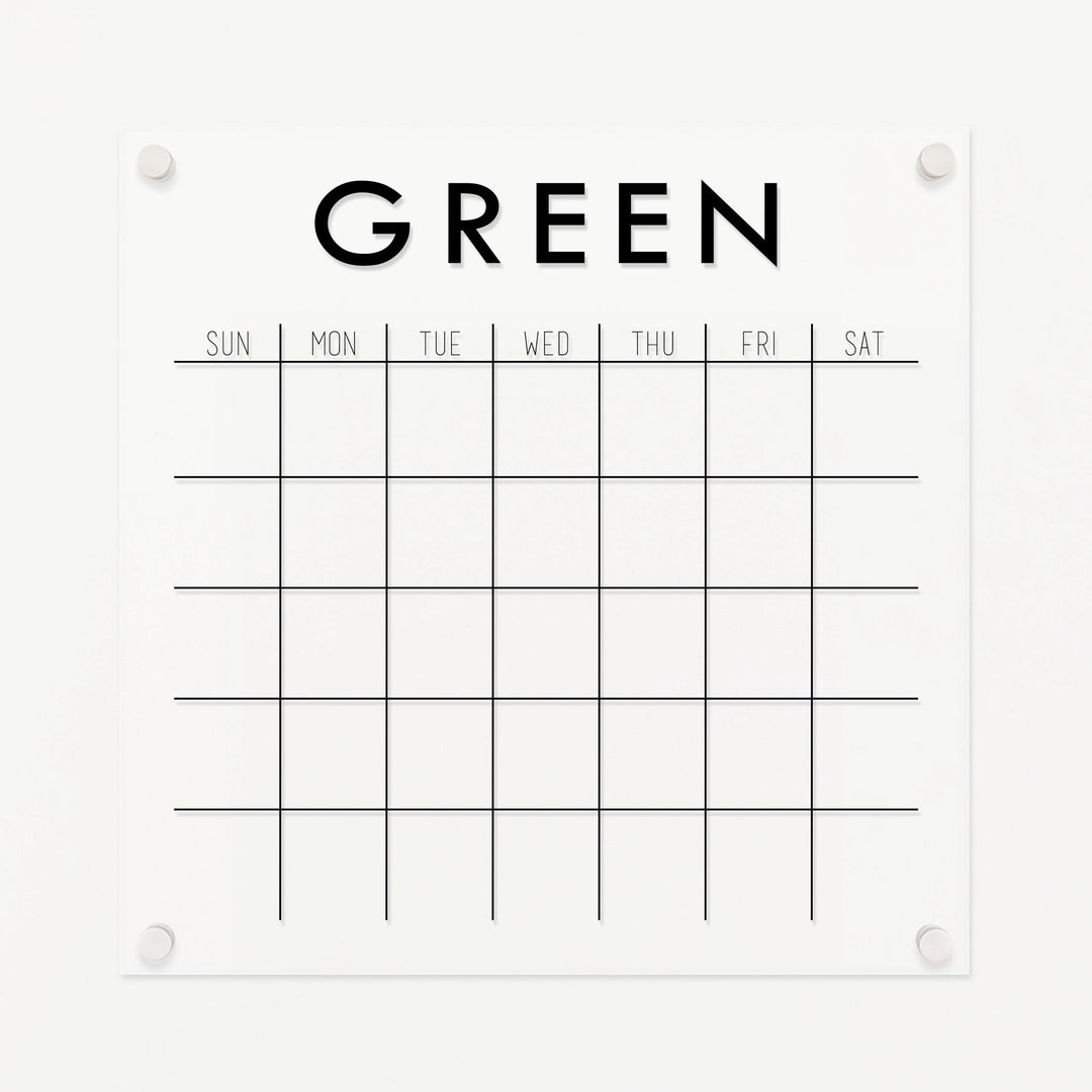 A Dry-erase monthly calender made of acrylic hanging on the wall