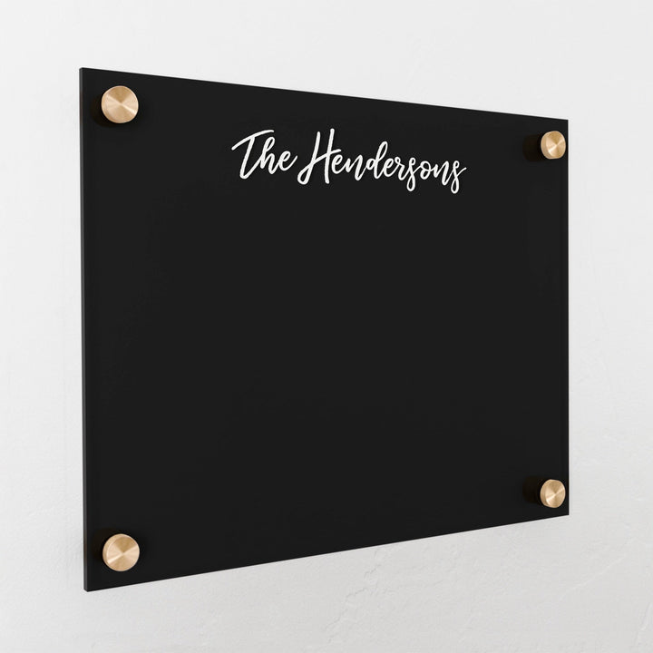 A dry-erase board made of clear acrylic with a custom title up top