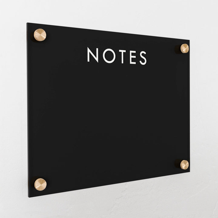 A dry-erase board made of clear acrylic with a custom title up top