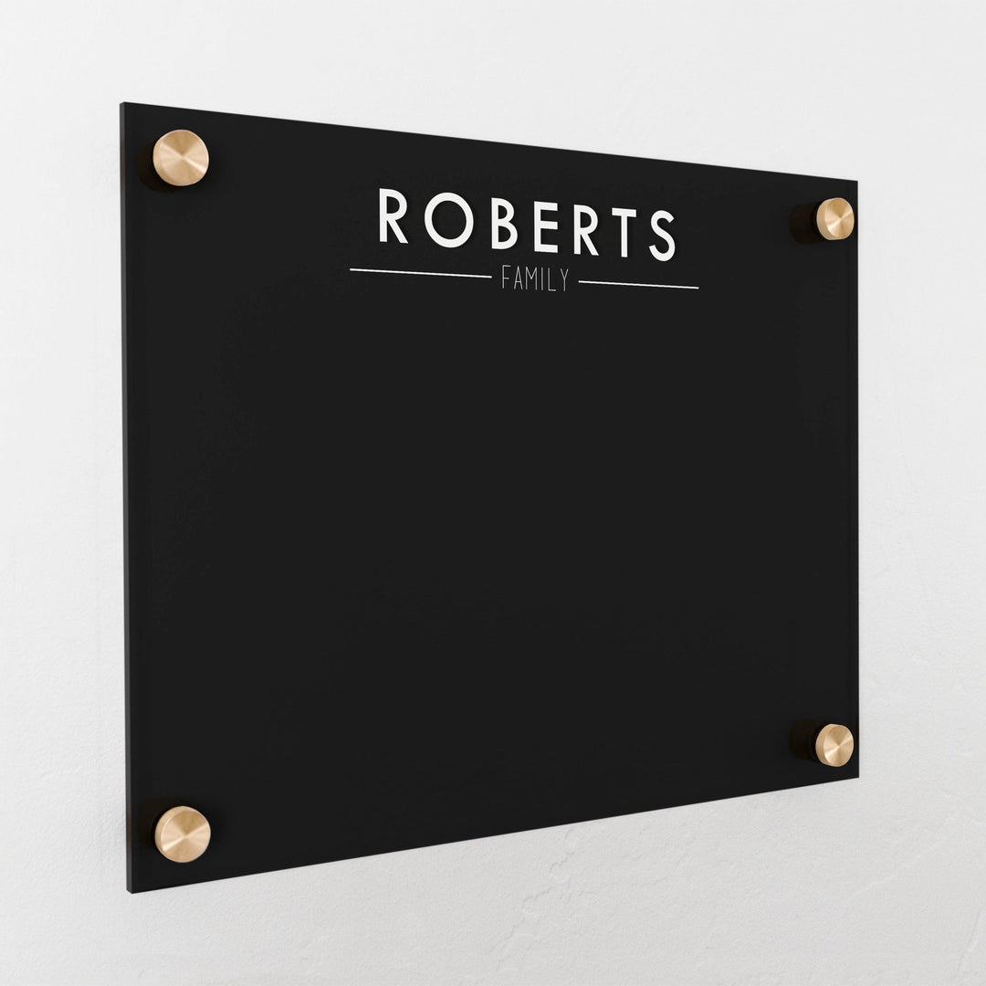 A dry-erase board made of clear acrylic with a custom title up top