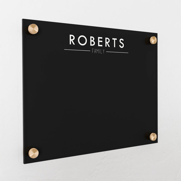 A dry-erase board made of clear acrylic with a custom title up top
