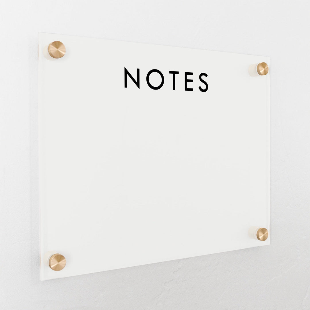 A dry-erase board made of clear acrylic with a custom title up top
