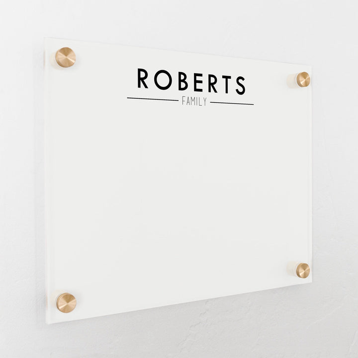 A dry-erase board made of clear acrylic with a custom title up top