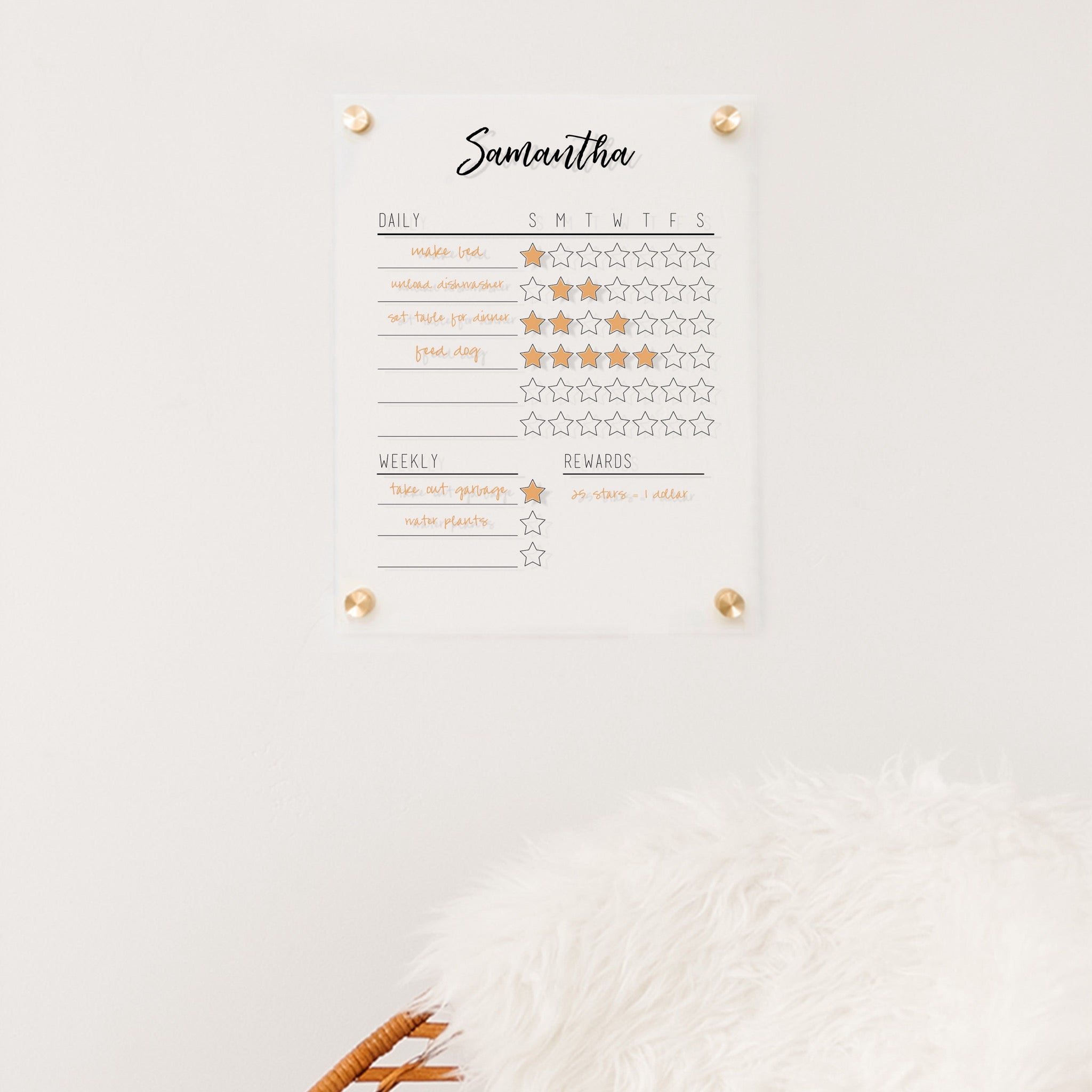 A Dry-erase acrylic reward chart hanging on the wall