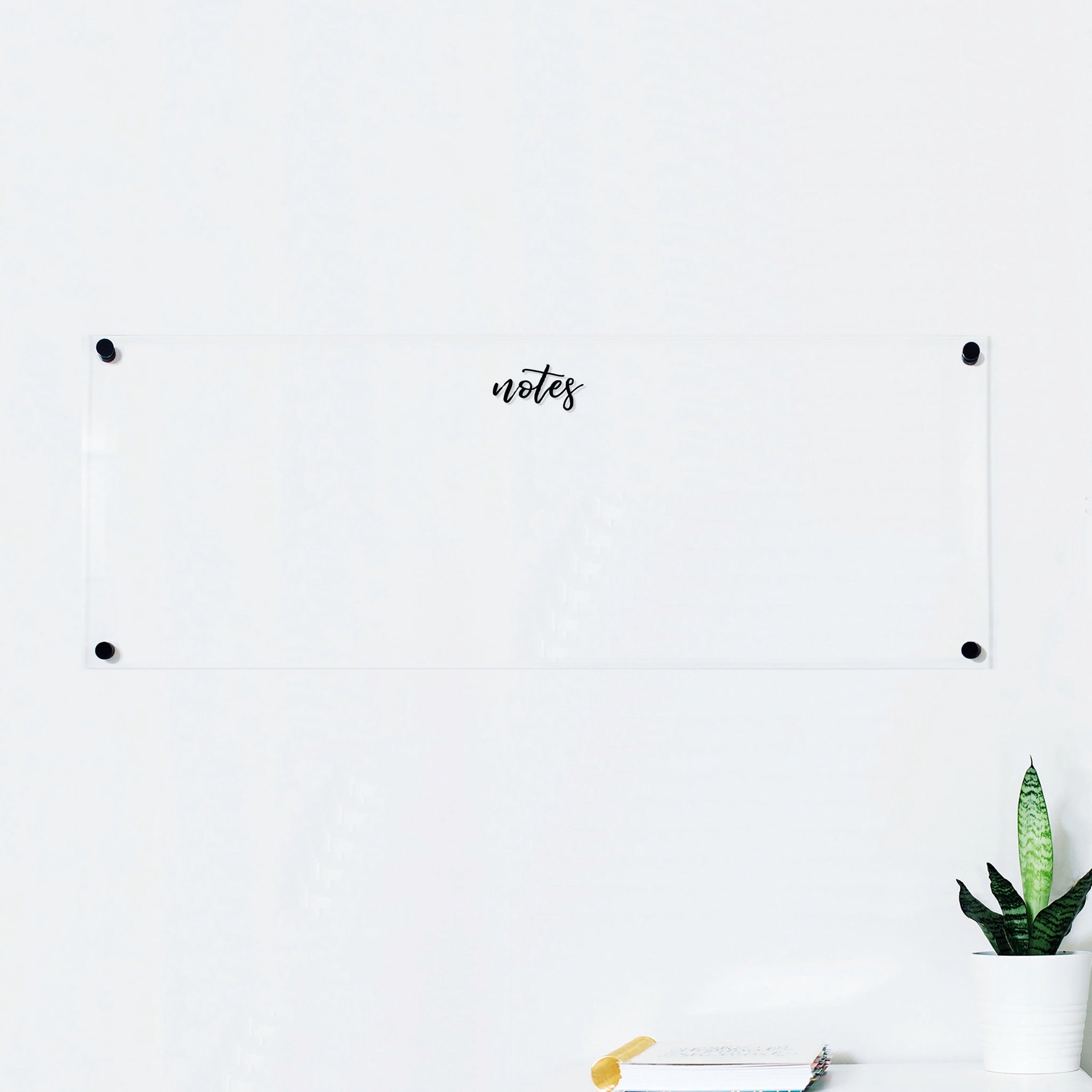 A dry-erase board made of clear acrylic with a custom title up top