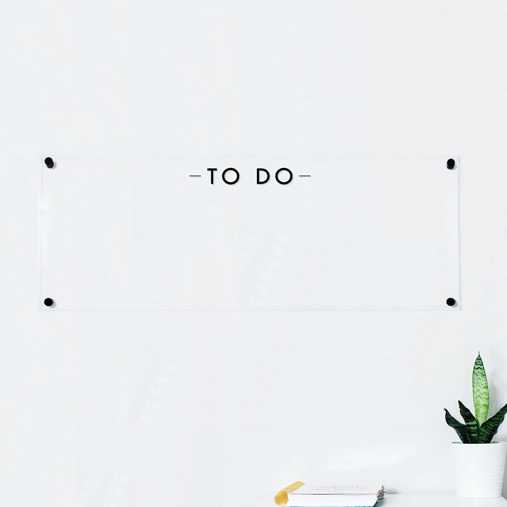 A dry-erase board made of clear acrylic with a custom title up top