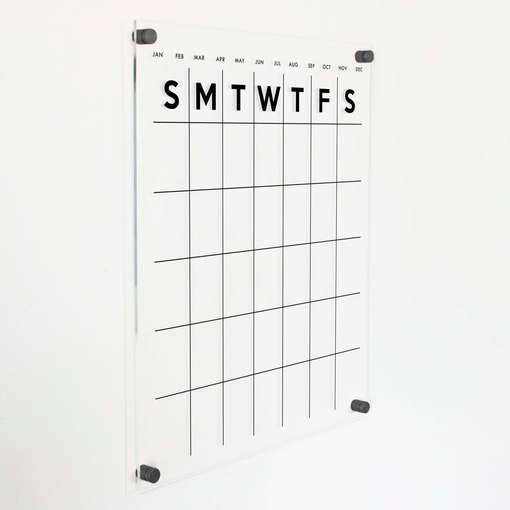 A Dry-erase monthly calender made of acrylic hanging on the wall