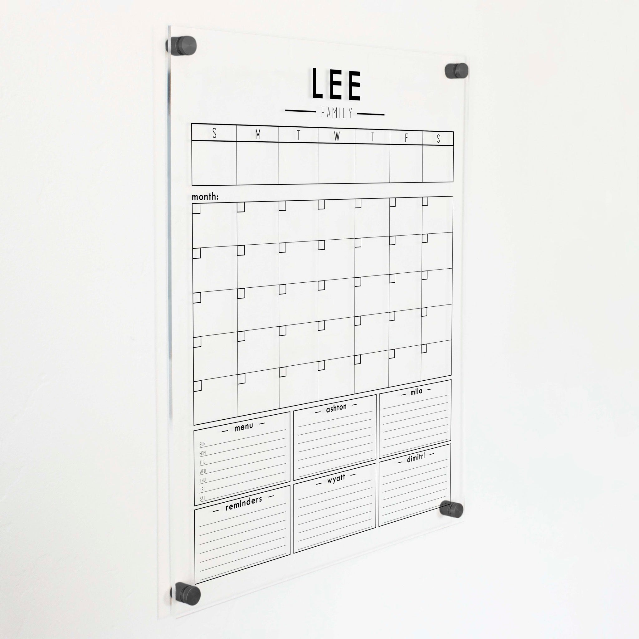 A Dry-erase calendar with a monthly and weekly format made of acrylic hanging on the wall