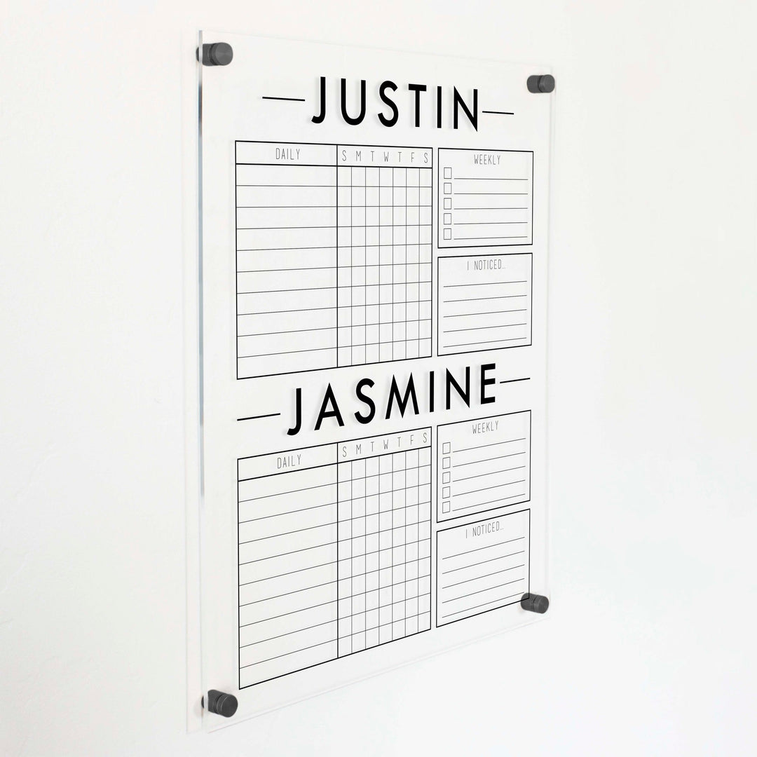 A Dry-erase acrylic chore chart hanging on the wall