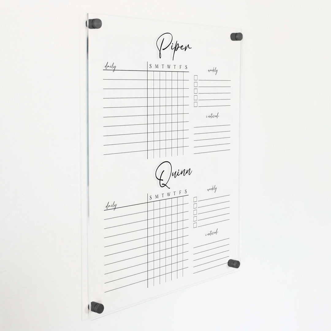A Dry-erase acrylic chore chart hanging on the wall