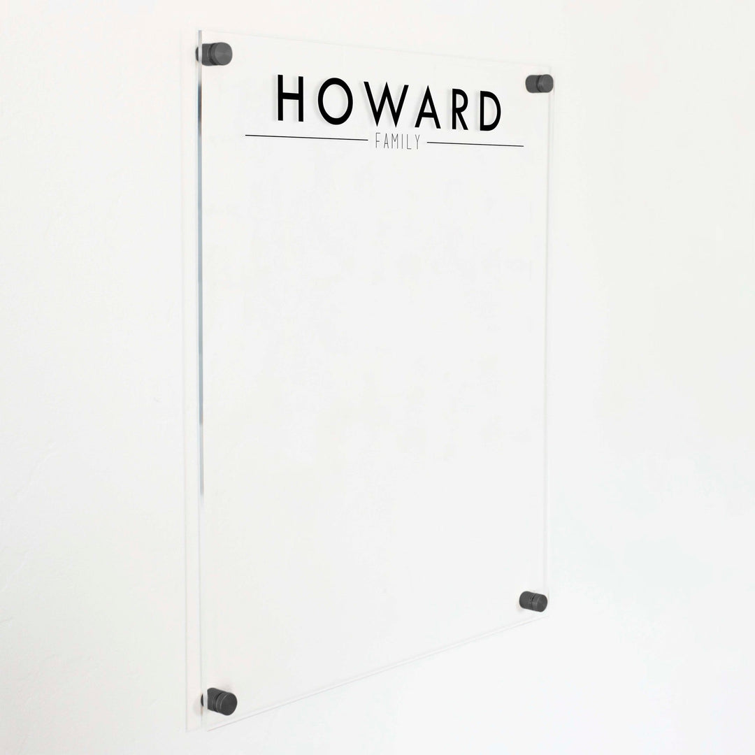 A dry-erase board made of clear acrylic with a custom title up top
