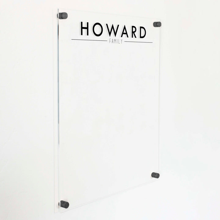A dry-erase board made of clear acrylic with a custom title up top
